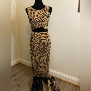 Fashion Nova midi dress size Large. Cut out at stomach ties. Animal print, split